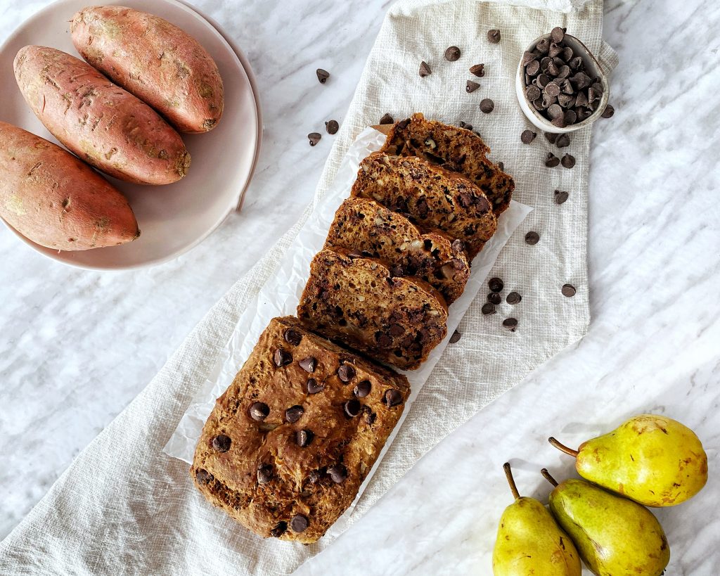 vegan sweet potato pear loaf cut in slices on cutting board