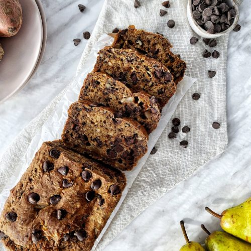 vegan sweet potato pear loaf sliced on a cutting board