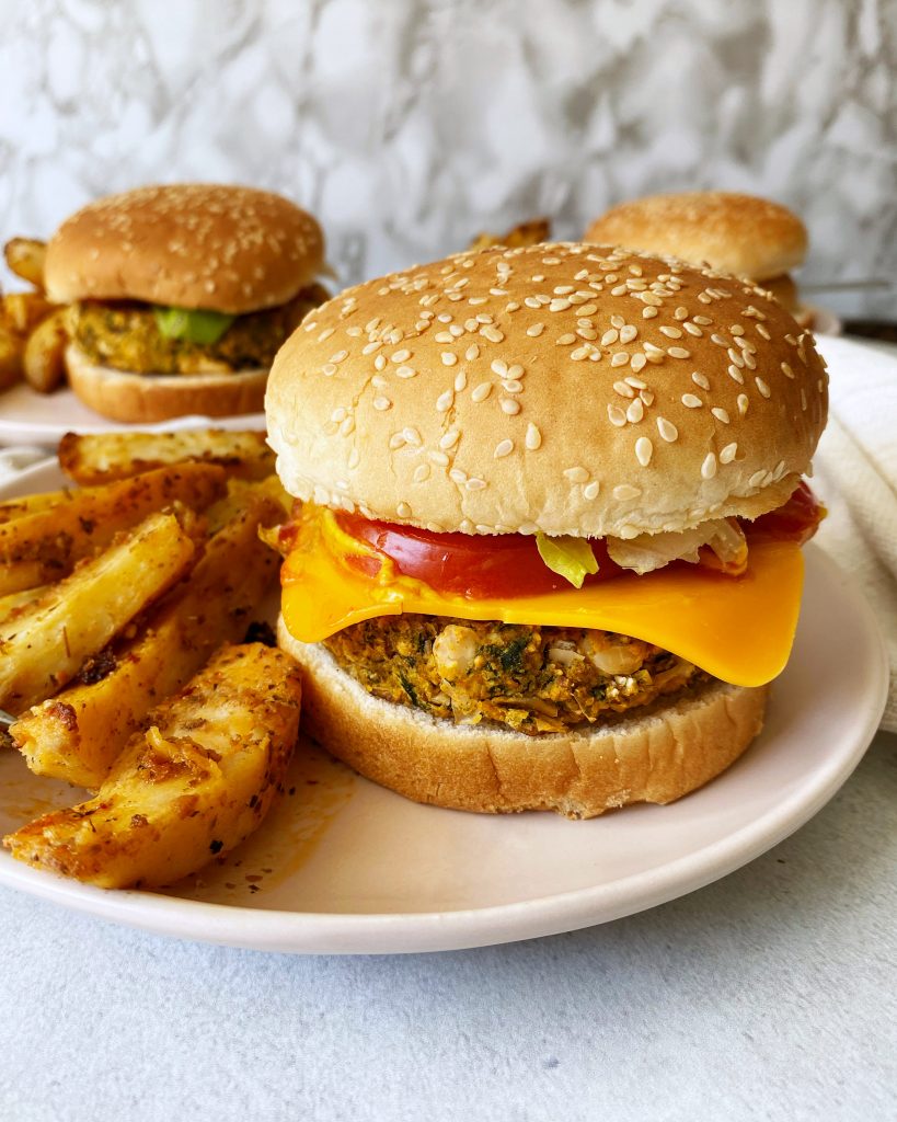 vegan white bean spinach burgers in a hamburger bun all dressed