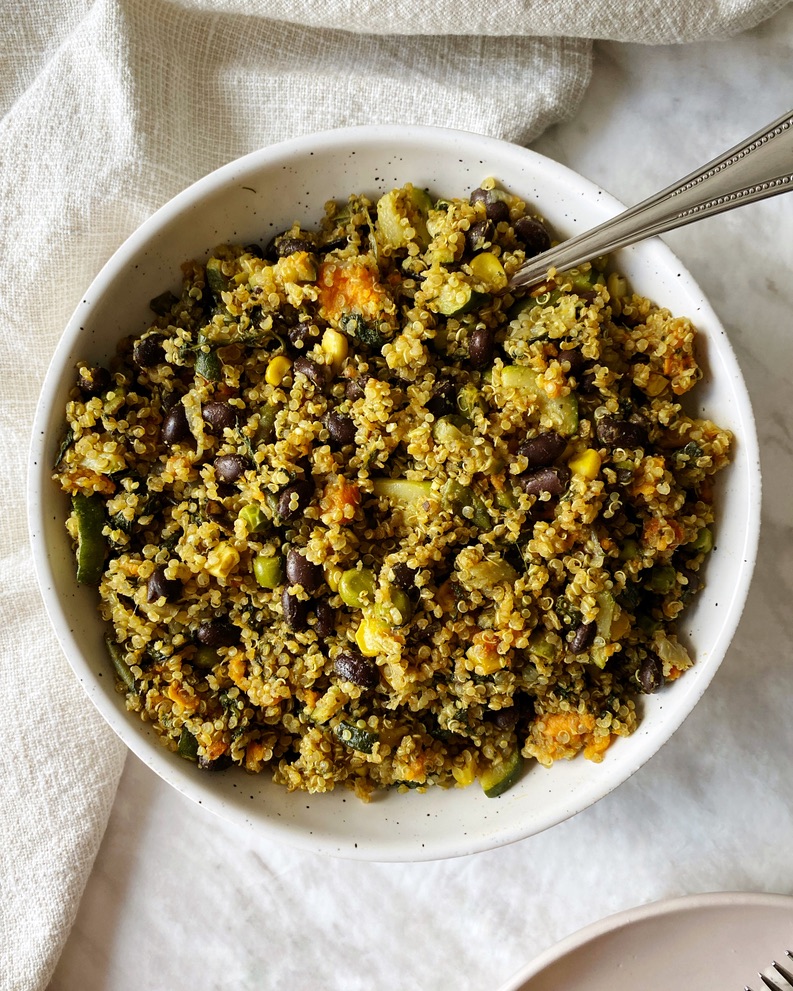 quinoa black bean salad in a serving bowl with a spoon