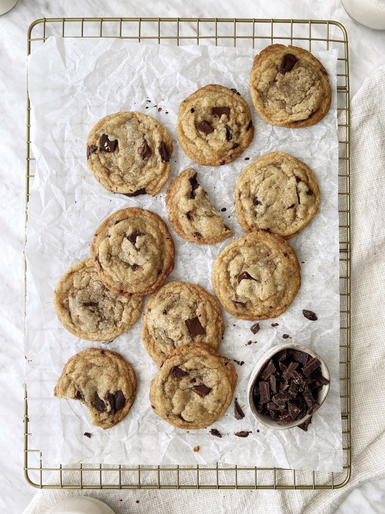 chewy vegan chocolate chip cookies on parchment paper-lined cooling rack