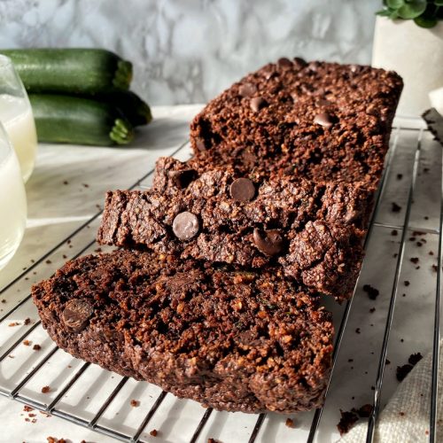 vegan gluten-free chocolate zucchini loaf cut into slices on a cooling rack