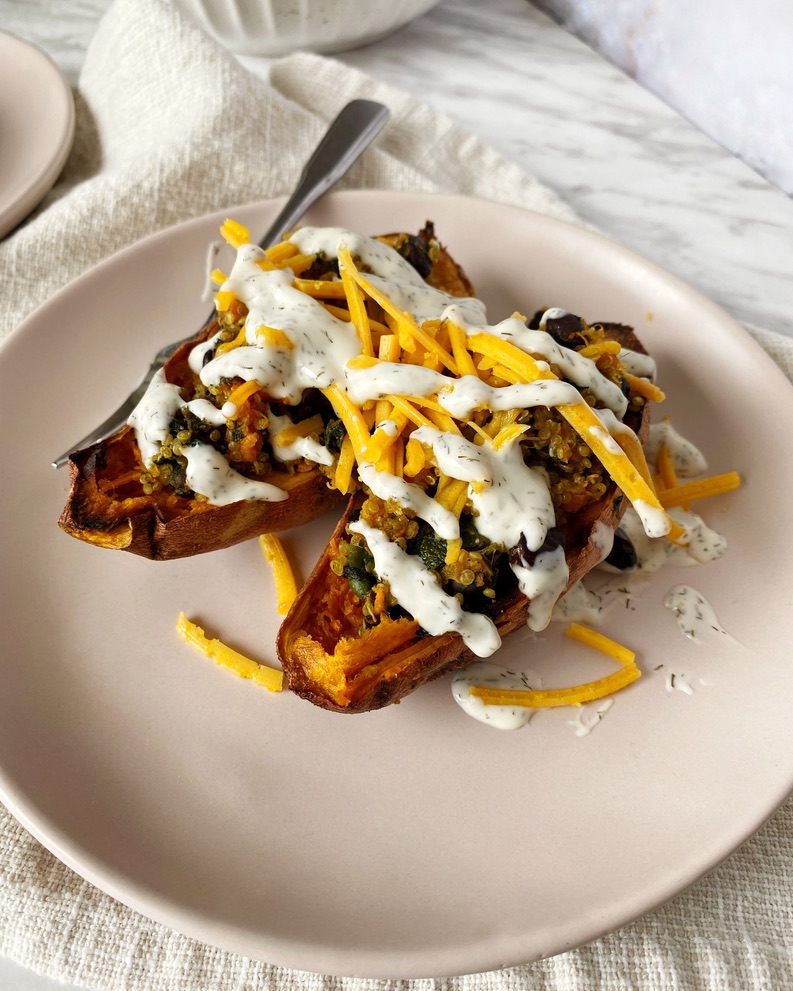 quinoa stuffed sweet potatoes in a plate cut in half