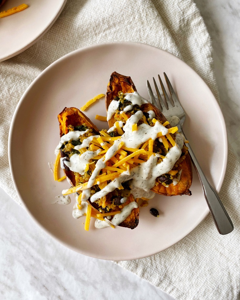 stuffed sweet potatoes with quinoa topped with cheese and garlic aioli mayo