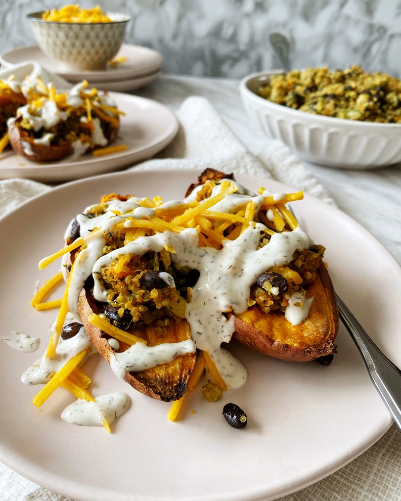 quinoa stuffed sweet potato topped with vegan cheese