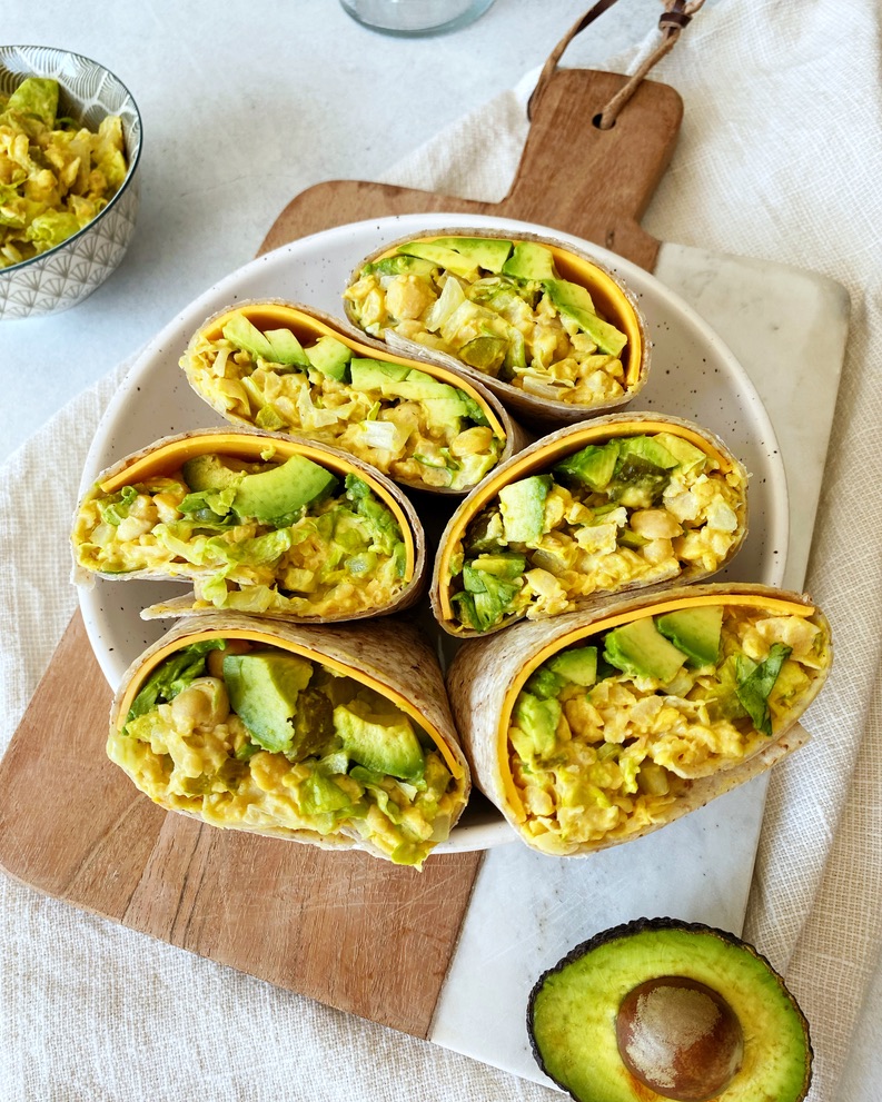 chickpea "egg" salad wrap halves lined up in a round bowl