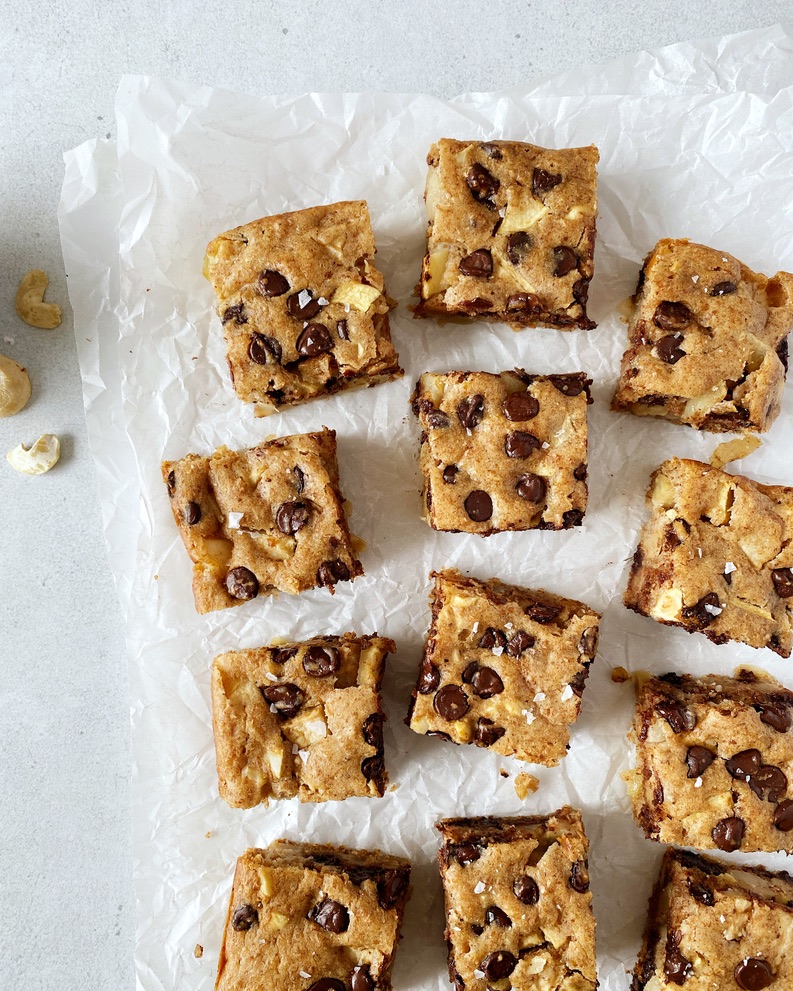 overhead shot of apple blondie squares spread out on parchment paper