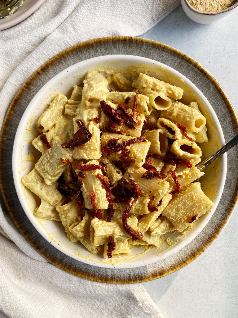 creamy vegan alfredo sauce with sun-dried tomatoes in a bowl