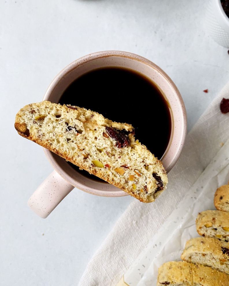 Biscotti placed on top of a pink coffee mug