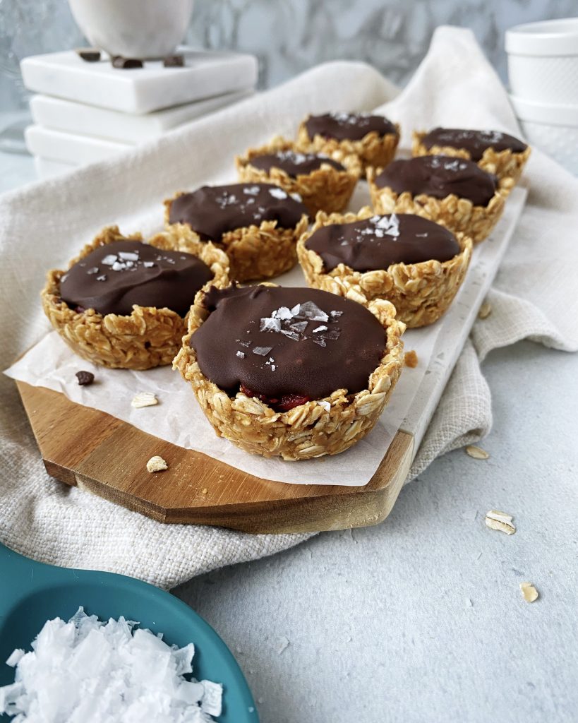 berry oat cups lined up on marble serving tray