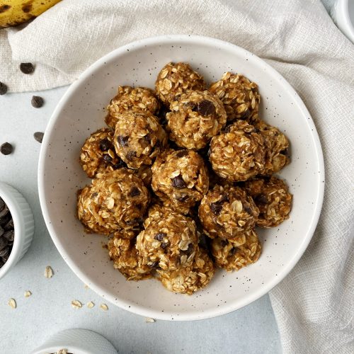 no bake banana bread energy balls stacked up in a white bowl