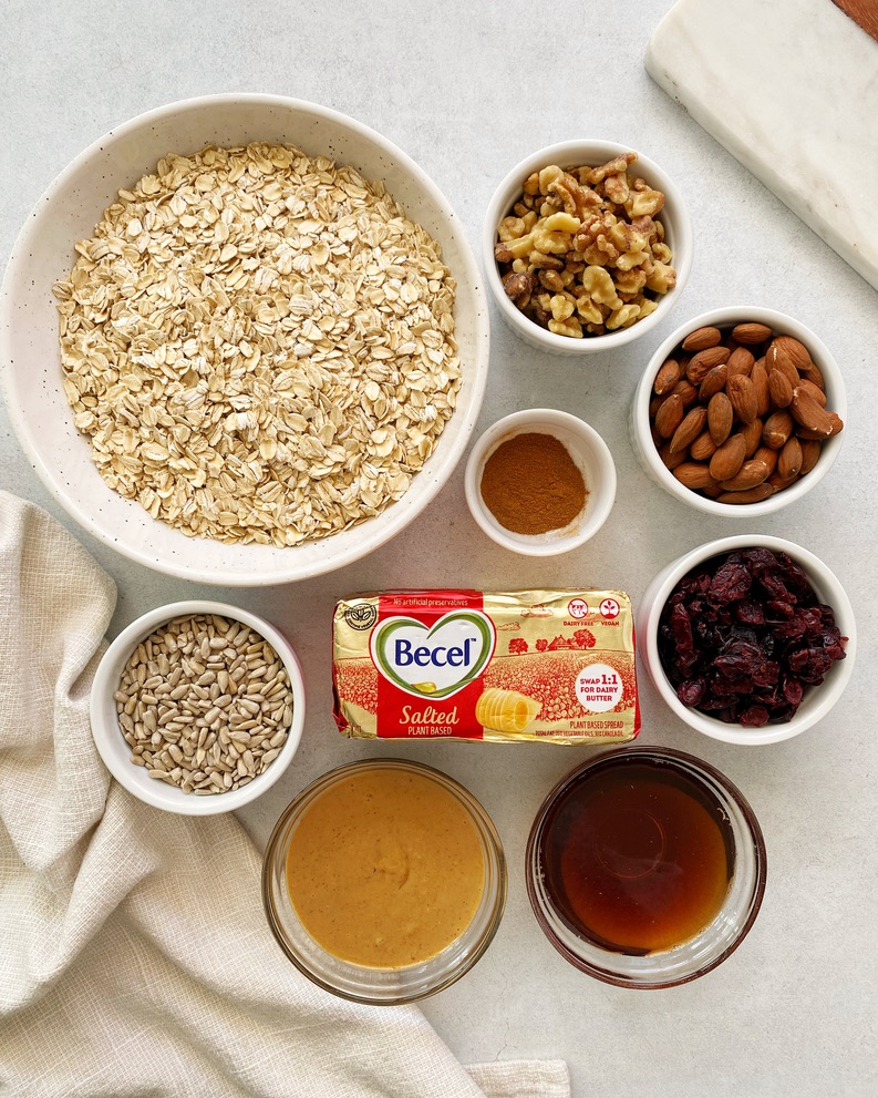 ingredients for vegan peanut butter granola in separate small bowls.