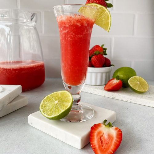 Strawberry Daiquiri in a tall thin glass on a marble coaster