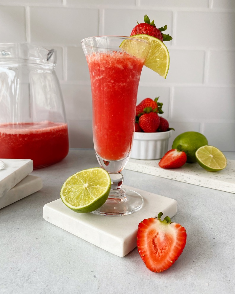 Strawberry Daiquiri in a tall thin glass on a marble coaster