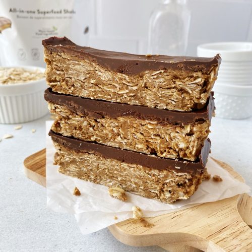 three protein bars stacked on top of each others on small wooden board