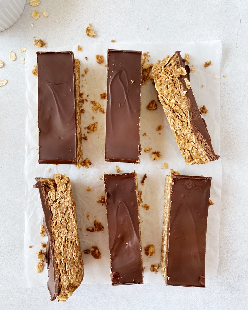 protein bars lined up on a parchment paper three by three