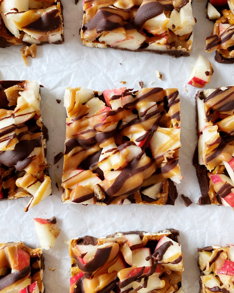 close up of one piece of caramel apple bark on parchment paper