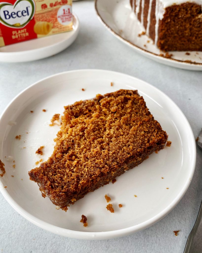 slice of gingerbread loaf on small plate with a bite taken out of it
