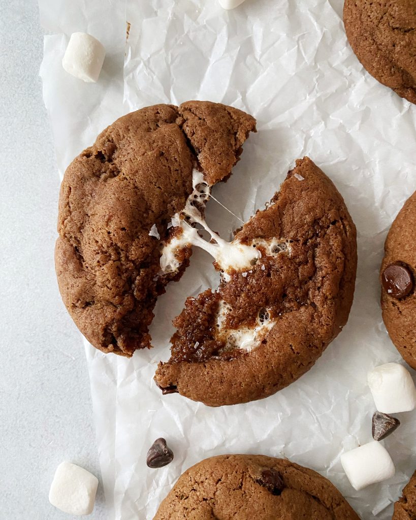 vegan hot chocolate cookies cut in half with marshmallow pull in the centre
