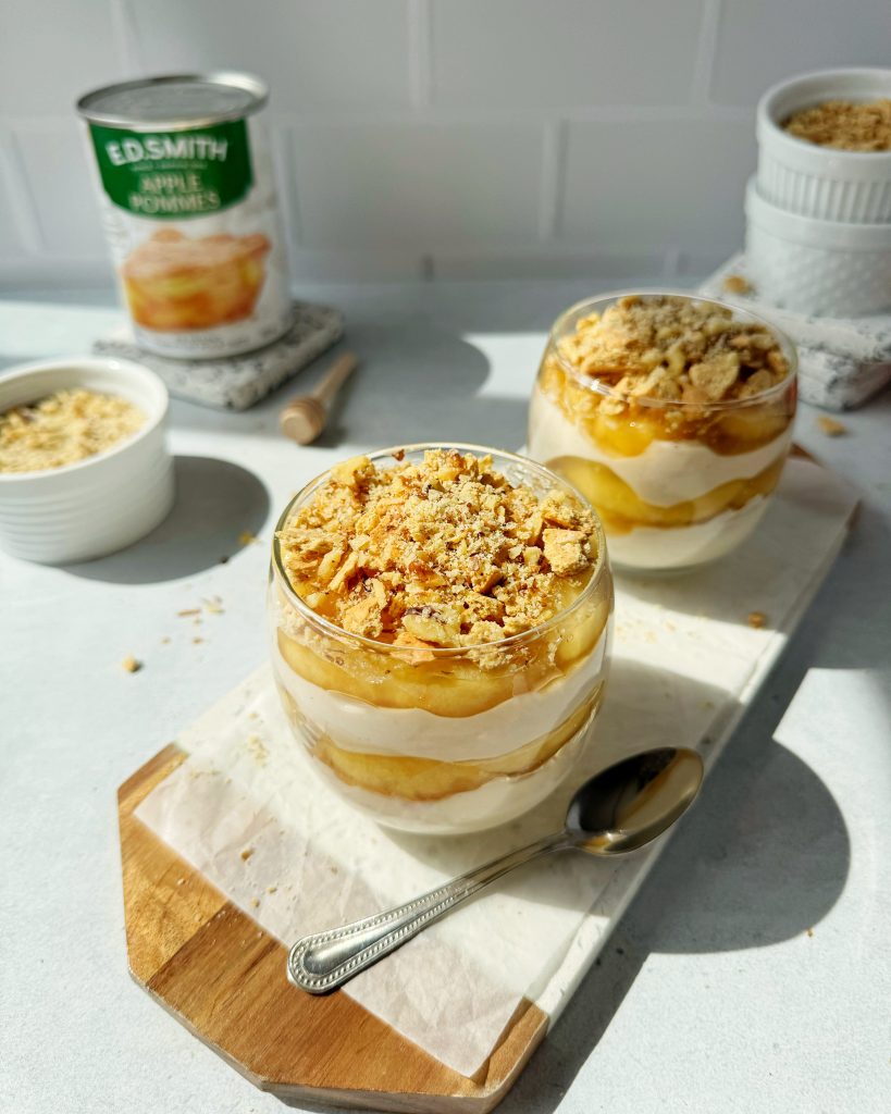 overhead shot of apple pie yogurt parfait showing crushed graham crackers and walnuts on top