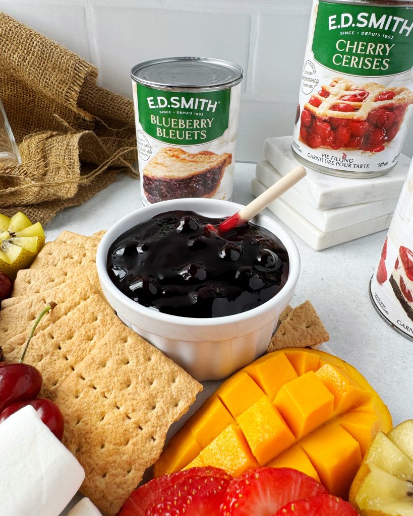 close up of blueberry pie filling on summer fruit board