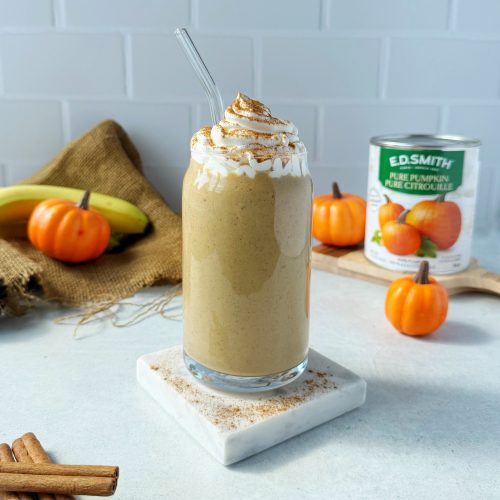 pumpkin pie smoothie topped with whipped cream on a marble coaster