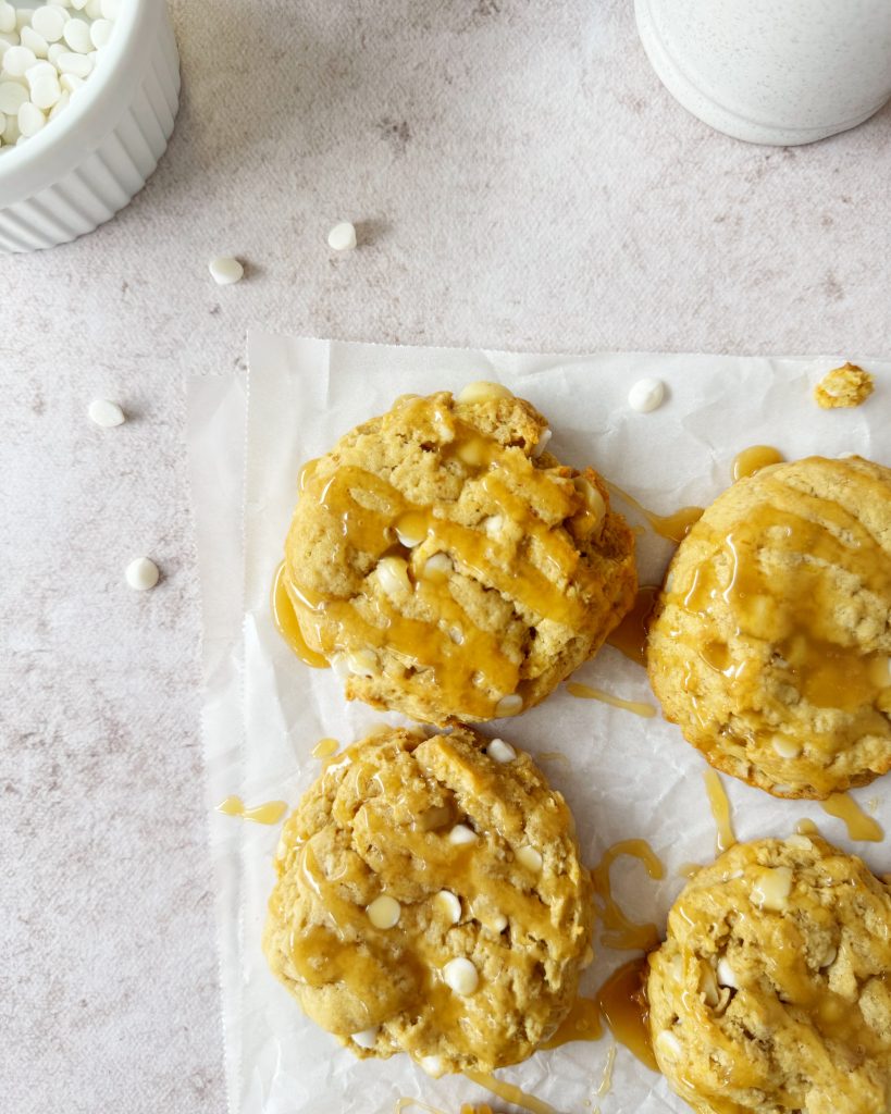 vegan salted caramel cookies with a caramel sauce drizzled over the cookies