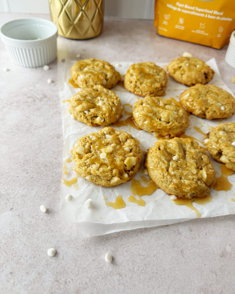 salted caramel cookies drizzled with caramel on a parchment paper