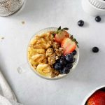 high protein yogurt bowl topped with fruit and granola