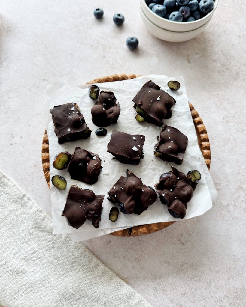chocolate covered blueberry chunks on parchment paper
