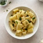 garlic bread pasta topped with breadcrumbs and parsley