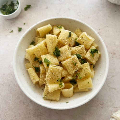 garlic bread pasta topped with breadcrumbs and parsley