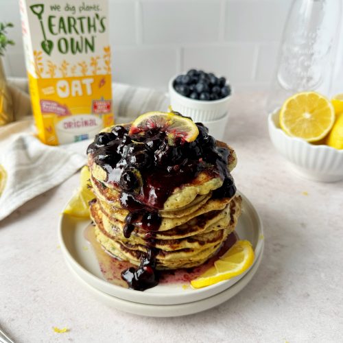 lemon blueberry pancakes topped with blueberry compote and lemon slice